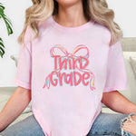 Load image into Gallery viewer, Preppy Bow Grade Level Tees on Comfort Colors (Shown on Blossom)
