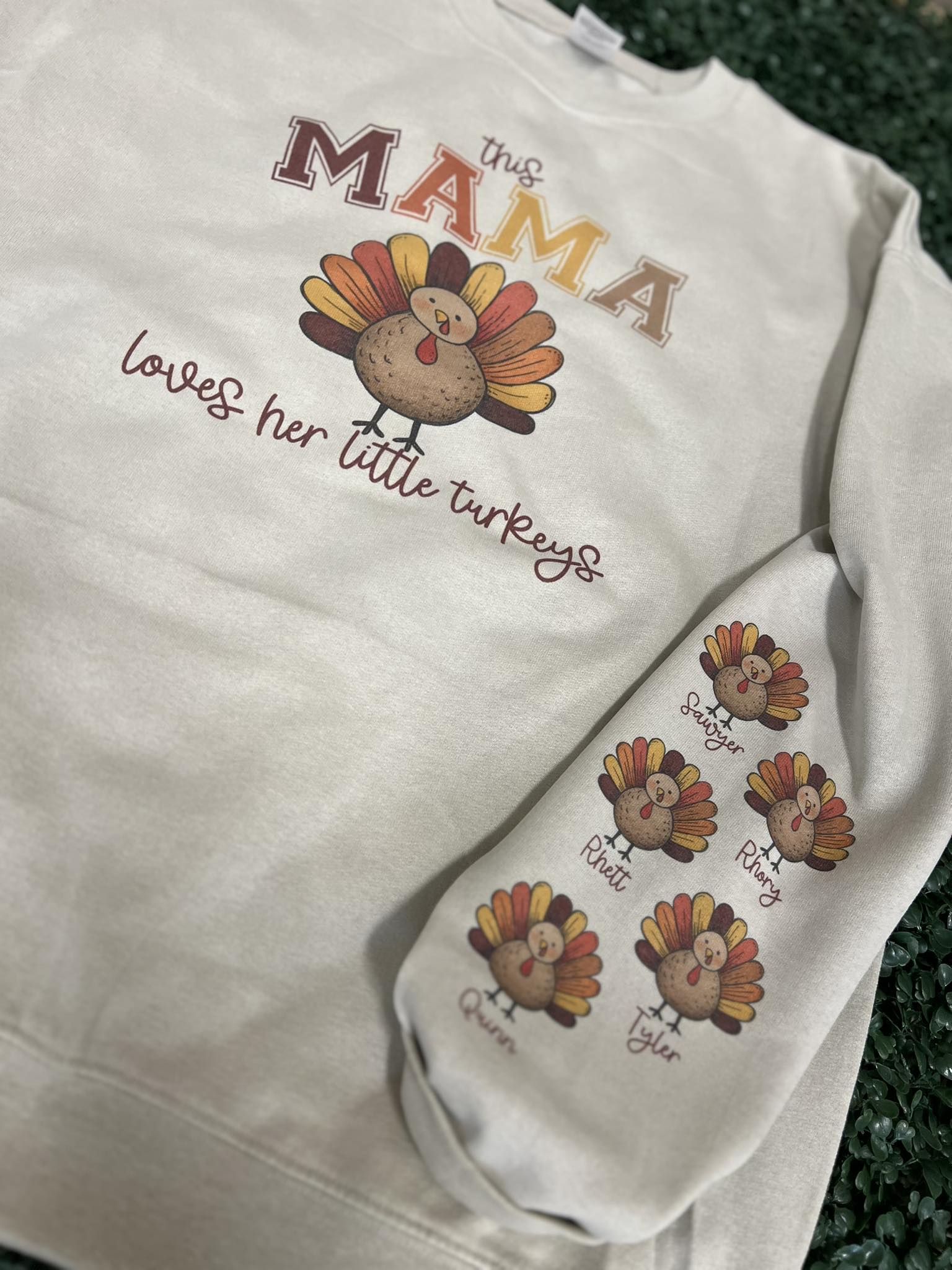 This Mama Loves Her Little Turkeys Customizable Sweatshirt with Optional Names on Sleeve on Sand