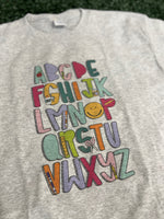 Load image into Gallery viewer, Teacher Alphabet on Ash Gray Tee
