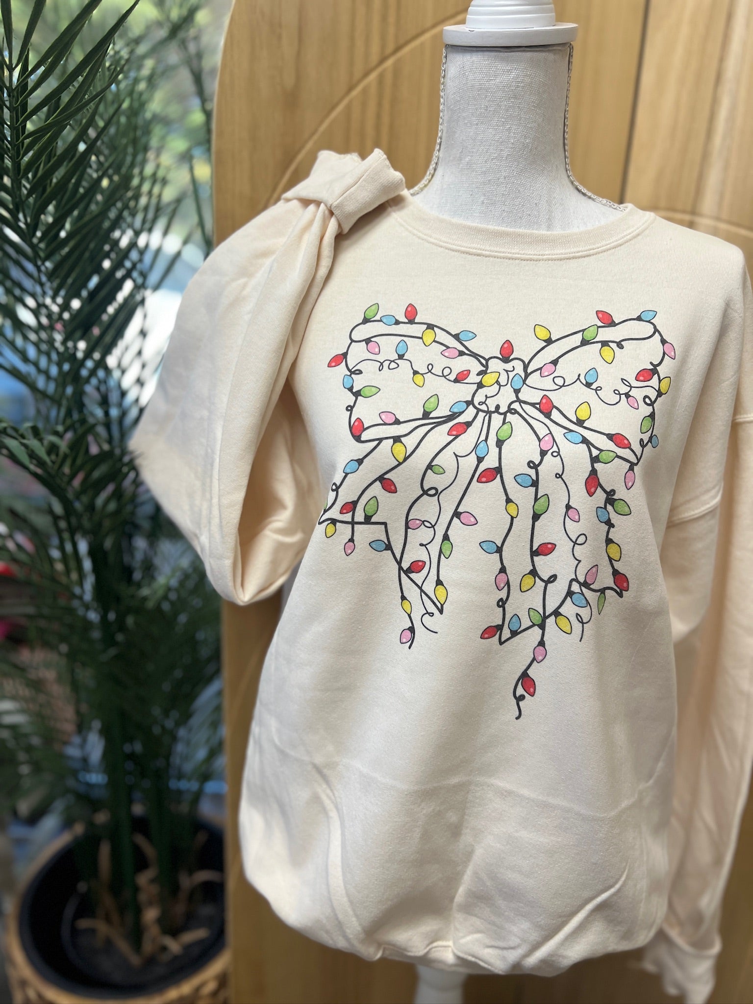 Christmas Lights Bow Sweatshirt on Cream