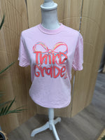 Load image into Gallery viewer, Preppy Bow Grade Level Tees on Comfort Colors (Shown on Blossom)
