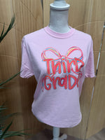 Load image into Gallery viewer, Preppy Bow Grade Level Tees on Comfort Colors (Shown on Blossom)

